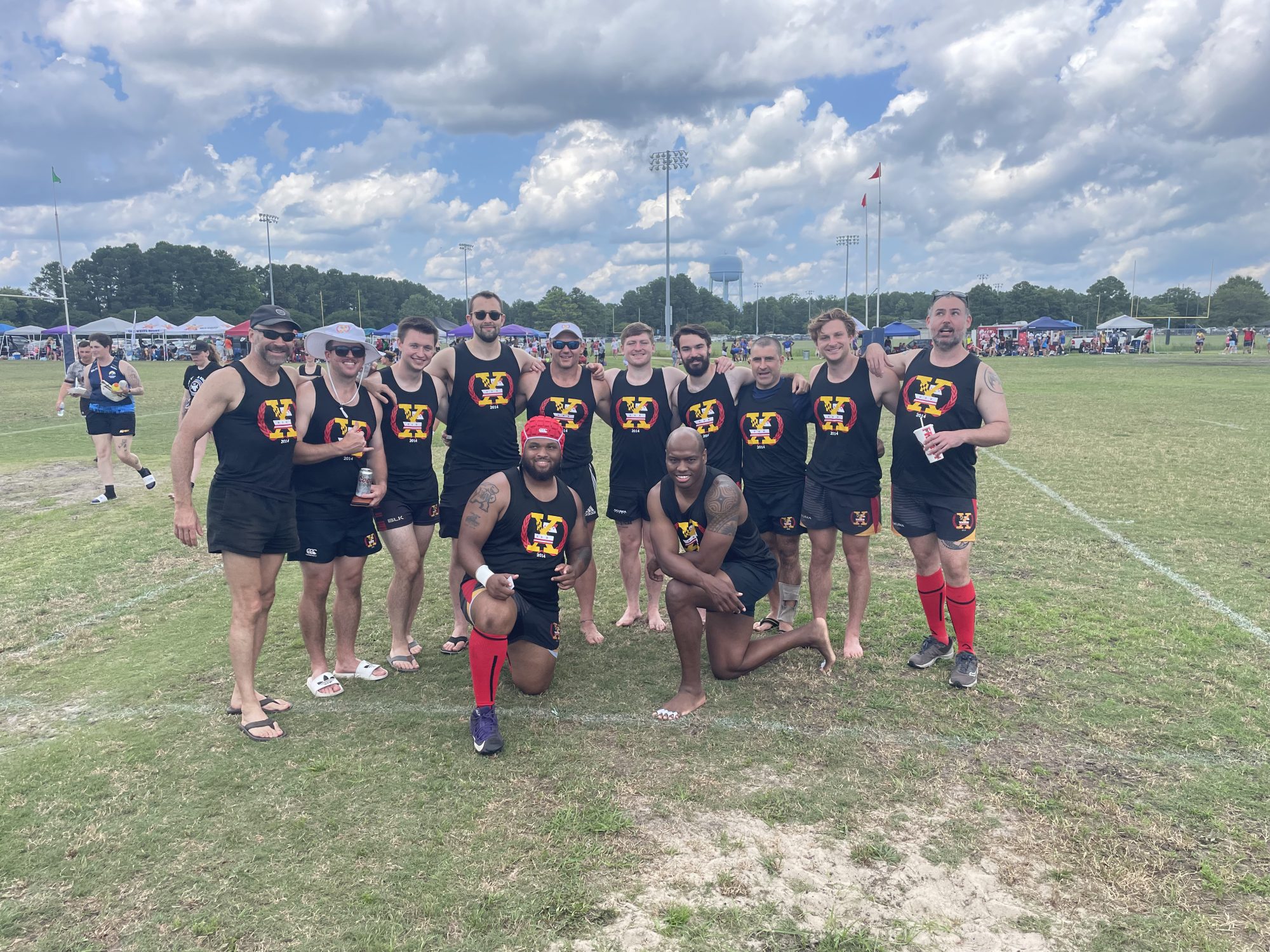 Rugby players take a team picture in between matches. Tank tops and short shorts dominate the outfits!